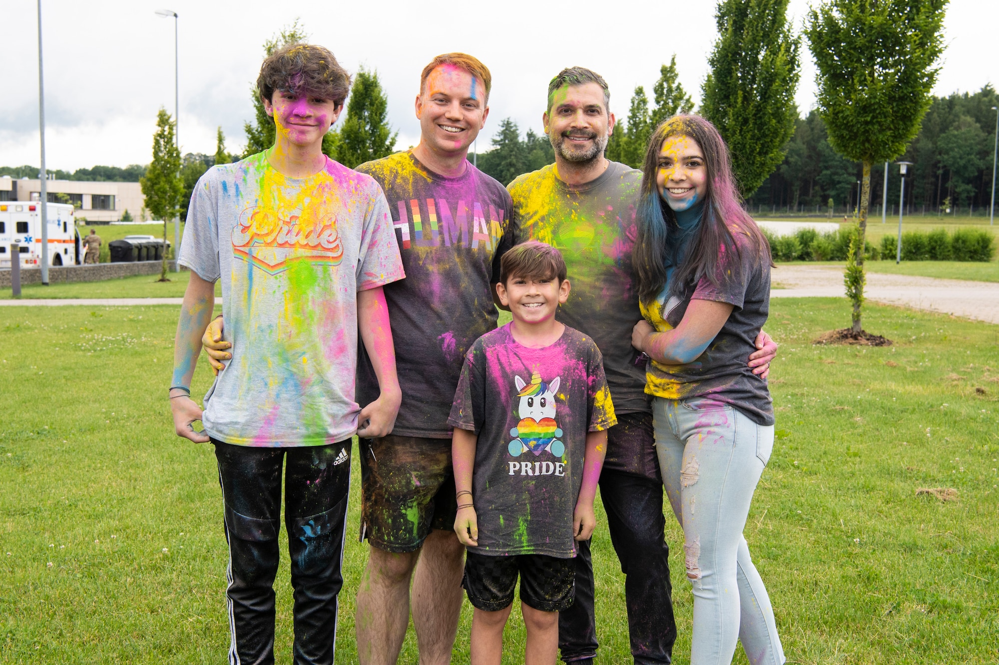 U.S. Air Force Tech. Sgt. Bryan Driscoll, 52nd Contracting Squadron contracting officer, poses for a photo with his spouse, Joel Cutter, and their children during a color run June 30, 2021, on Spangdahlem Air Base, Germany. During Pride Month, the United States  recognizes the valuable contributions of the lesbian, gay, bisexual, transgender, and queer community. (U.S. Air Force photo by Staff Sgt. Melody W. Howley)