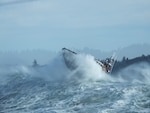 Petty Officer 2nd Class Enrique Lemos (surfman #559) operates a 47-foot Motor Lifeboat near the entrance to the Umpqua River in Winchester Bay, Oregon, Dec. 26, 2019. Lemos was one of 10 Coast Guardsmen to certify as a surfman during the winter and spring. (U.S. Coast Guard photo courtesy of Petty Officer 2nd Class Enrique Lemos)