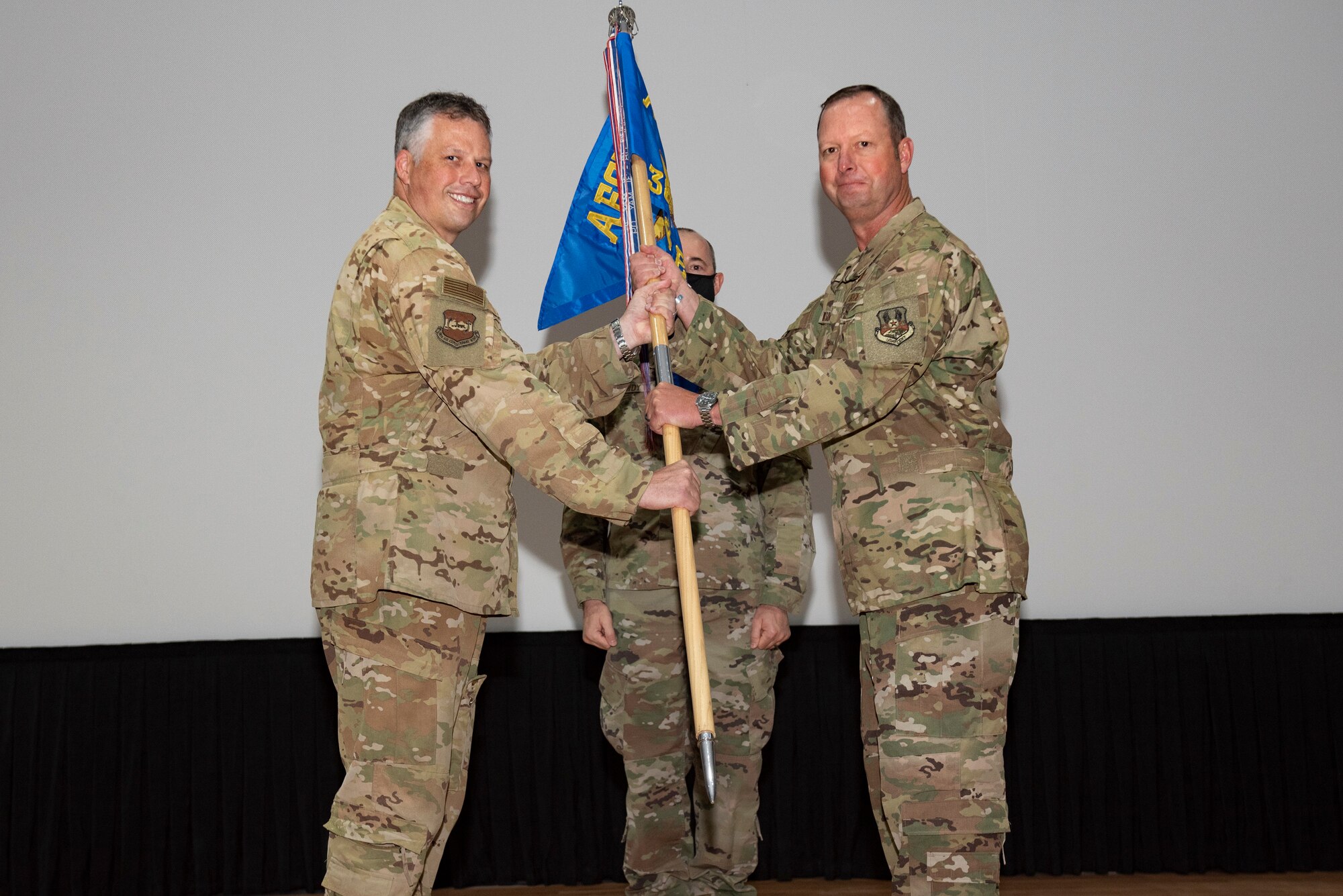 A photo of Airmen holding a guidon