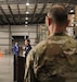 Kentucky Army National Guard 1st Sgt. Dylan Molohon listens as Governor Andy Beshear speaks during a press conference held at the supply warehouse in Frankfort, Ky., Sept. 10, 2020.