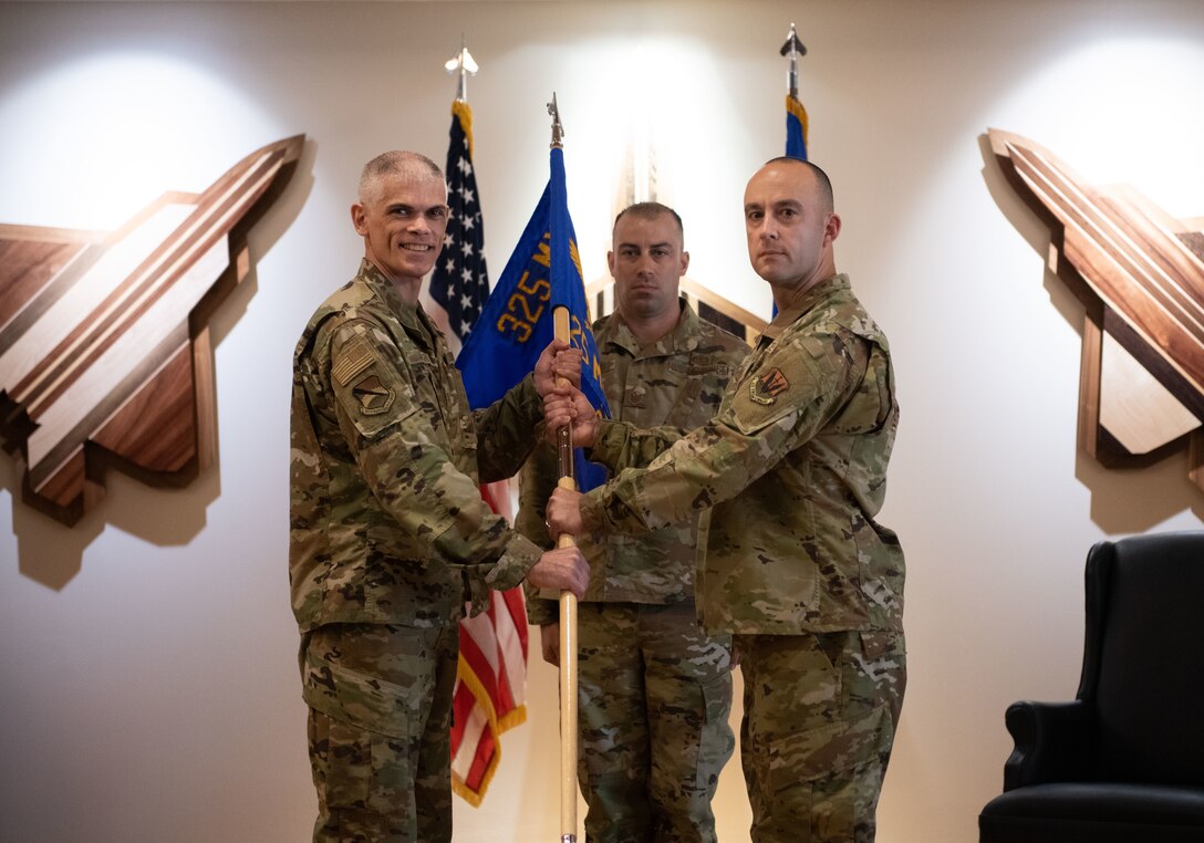 U.S. Air Force Col. Steven Collen (left), 325th Maintenance Group commander, gives command of the 325th Munitions Squadron to Maj. Justin Cassidy (right), during an activation ceremony at Tyndall Air Force Base, Florida, June 29, 2021. The 325th MUNS is tasked with safeguarding and maintaining Tyndall’s $275 million in munitions in support of projecting unrivaled combat airpower. (U.S. Air Force photo by Staff Sgt. Stefan Alvarez)