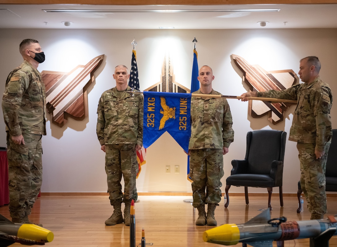 The official guidon of the 325th Munitions Squadron is unveiled at an activation ceremony at Tyndall Air Force Base, Florida, June 29, 2021. The 325th MUNS supports the requirements of the United States Air Force Weapons School, Weapons Instructor Course, Air Force Civil Engineer Center, Air Force Research Lab, and the Naval Diving and Salvage Training Center. (U.S. Air Force photo by Staff Sgt. Stefan Alvarez)