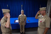 210701-N-IO414-1040 NAVAL SUPPORT ACTIVITY BAHRAIN (July 1, 2021) - Capt. Michael O’Driscoll, right, outgoing commander of Task Force (TF) 53, salutes Capt. Michael Toth, left, incoming commander of TF 53, during a change of command ceremony presided over by Rear Adm. Sean Bailey, deputy commander of U.S. Naval Forces Central Command and U.S. 5th Fleet, onboard Naval Support Activity Bahrain, July 1. TF 53 coordinates replenishment-at-sea efforts and delivers passengers, mail, cargo, ammunition, provisions and fuel throughout the 5th Fleet area of operations via air, land and sea modes, helping to ensure Sailors aboard ships have what they need to complete their missions. (U.S. Navy photo by Mass Communication Specialist 2nd Class Jordan Crouch)