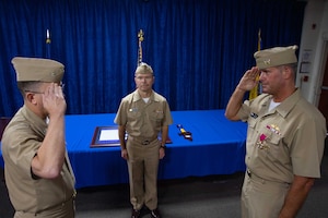 210701-N-IO414-1040 NAVAL SUPPORT ACTIVITY BAHRAIN (July 1, 2021) - Capt. Michael O’Driscoll, right, outgoing commander of Task Force (TF) 53, salutes Capt. Michael Toth, left, incoming commander of TF 53, during a change of command ceremony presided over by Rear Adm. Sean Bailey, deputy commander of U.S. Naval Forces Central Command and U.S. 5th Fleet, onboard Naval Support Activity Bahrain, July 1. TF 53 coordinates replenishment-at-sea efforts and delivers passengers, mail, cargo, ammunition, provisions and fuel throughout the 5th Fleet area of operations via air, land and sea modes, helping to ensure Sailors aboard ships have what they need to complete their missions. (U.S. Navy photo by Mass Communication Specialist 2nd Class Jordan Crouch)