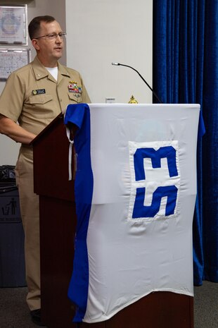 210701-N-IO414-1049 NAVAL SUPPORT ACTIVITY BAHRAIN (July 1, 2021) - Capt. Michael Toth, incoming commander of Task Force (TF) 53, delivers remarks during a change of command ceremony onboard Naval Support Activity Bahrain, July 1. TF 53 coordinates replenishment-at-sea efforts and delivers passengers, mail, cargo, ammunition, provisions and fuel throughout the 5th Fleet area of operations via air, land and sea modes, helping to ensure Sailors aboard ships have what they need to complete their missions. (U.S. Navy photo by Mass Communication Specialist 2nd Class Jordan Crouch)