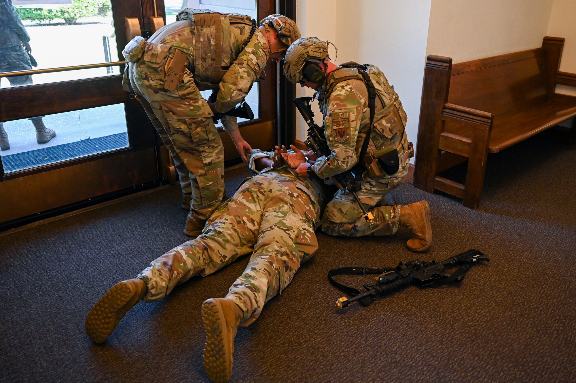 Airmen from the 633rd Security Forces
Squadron apprehend a simulated active
shooter during a base exercise at Joint Base
Langley-Eustis, Virginia, June 24, 2021. The
exercise was used to train readiness tactics
for real-world situations.