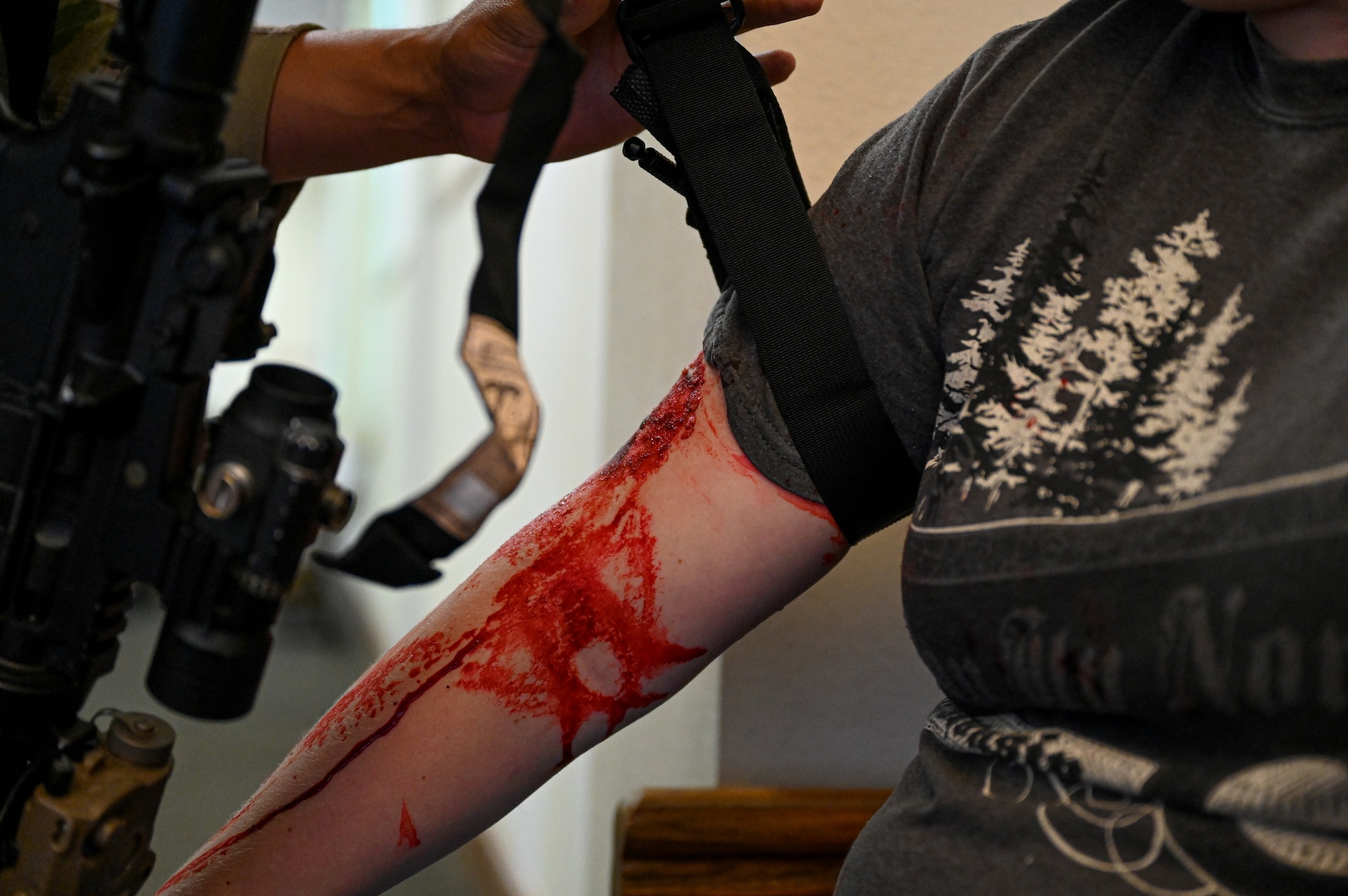 Senior Airman Nicholas Garcia, 633rd
Security Forces Squadron response force
team, ties a tourniquet on a simulated victim
during a base exercise at Joint Base
Langley-Eustis, Virginia, June 24, 2021. The
exercise was used to train readiness tactics
for security forces and medical personnel.
