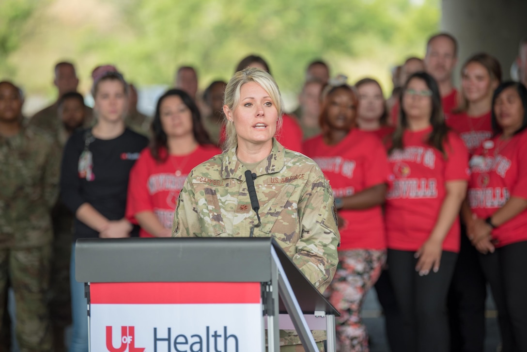 Maj. Tiffany Campbell, officer-in-charge of a Kentucky National Guard team that has supported a drive-thru COVID testing and vaccination site for 15 months, speaks during a ceremony to mark its closure in downtown Louisville, Kentucky, on June 30, 2021. The Guard has assisted medical staff from the University of Louisville with 17,160 COVID tests and the vaccination of more than 145,230 citizens. (U.S. Air National Guard photo by Phil Speck)
