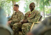 Incoming and outgoing Product Managers Soldier Precision Targeting Devices, Lt Cols. Aaron Pearsall and Jamal Williams respectively, sit together during their Change of Charter ceremony at Fort Belvoir, VA.