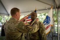 Outgoing Product Manager Soldier Precision Targeting Devices, Lt. Col. Jamal Williams receives awards and going away gifts during a Change of Charter ceremony held in Fort Belvoir, VA.