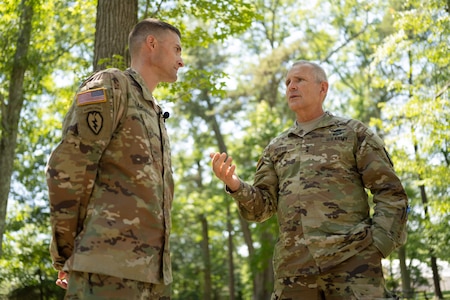 Incoming Product Manager Soldier Precision Targeting Devices, Lt. Col. Aaron Pearsall speaks with Maj. Gen. Tony Potts, PEO Soldier, during a Change of Charter ceremony held at Fort Belvoir, VA.