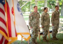 Project Manager Soldier Manuever and Precision Targeting leadership stand at attention for the playing of the Army Song during a Change of Charter ceremony in Fort Belvoir, VA.