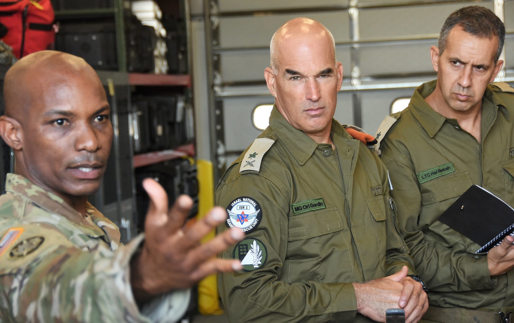 New York Army National Guard Maj. Del Gustave, assigned to the 24th Civil Support Team, briefs Israeli Maj. Gen. Ori Gordin, commander of the Israeli Defense Force Home Front Command, center, and Lt. Col. Hal Rekah, the Home Front Command liaison officer for the National Guard Bureau, during a capability brief of the CST for Home Front Command at Fort Hamilton, Brooklyn, N.Y. on June 28, 2021.