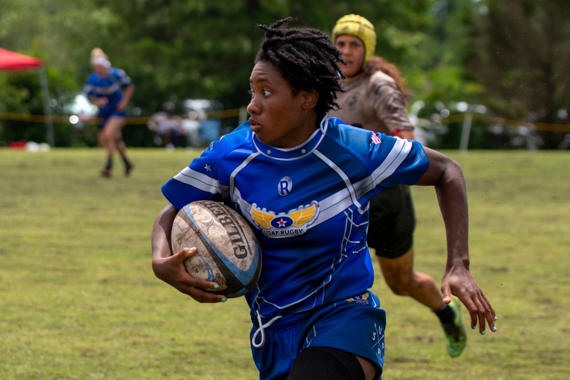 Staff Sgt. Cheryl Johnson, United States Air Force rugby player, runs with the ball at the Annual Armed Forces Women’s Rugby Championship in Wilmington, North Carolina, June 26, 2021.