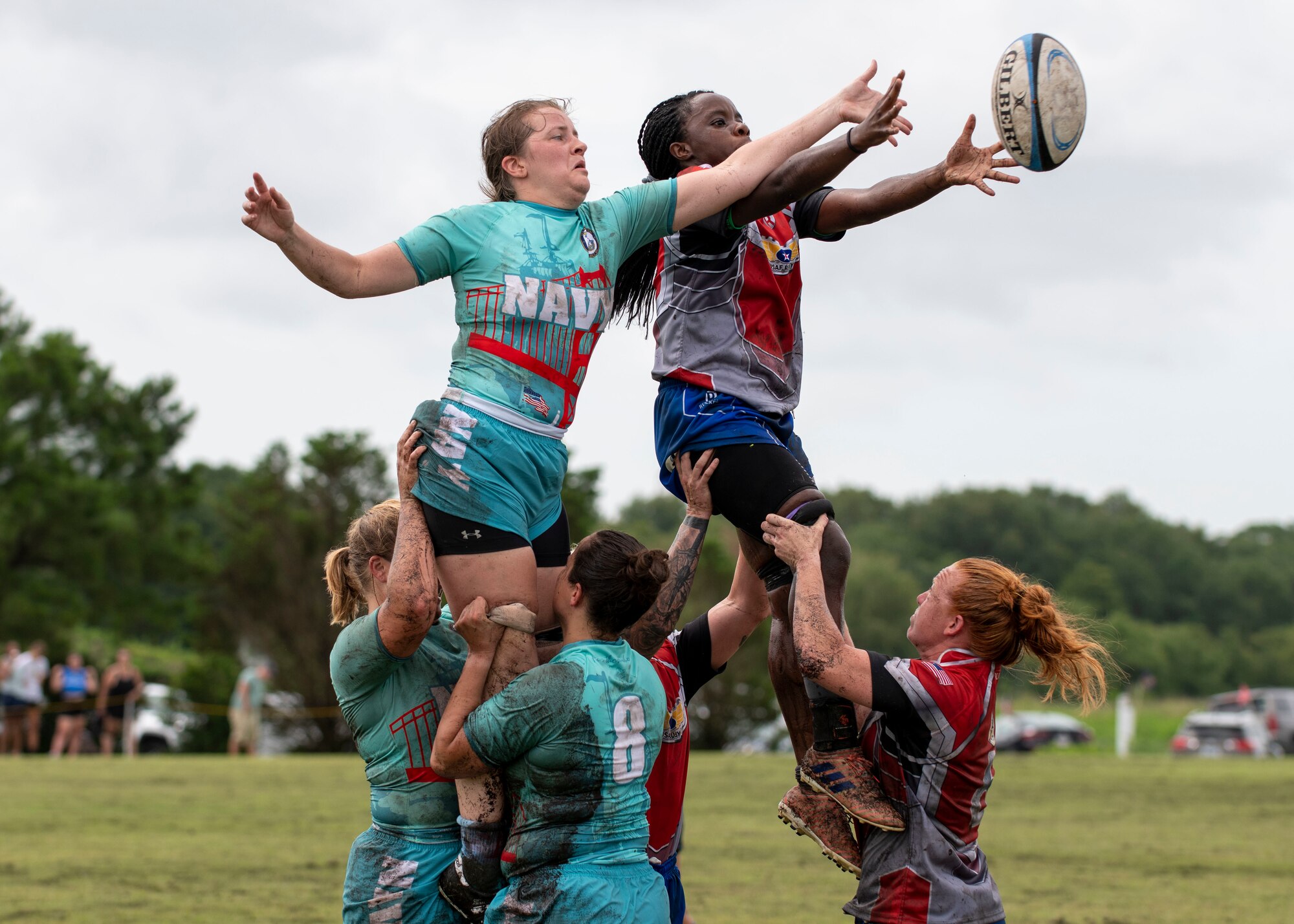 United States Air Force and Navy rugby players perform a line out at the Annual Armed Forces Women’s Rugby Championship in Wilmington, North Carolina, June 26, 2021.