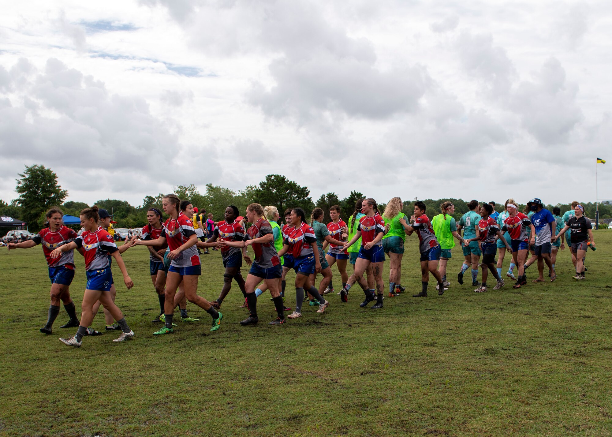 Members of the United States Air Force and Navy women’s rugby teams shake hands after a game at the Annual Armed Forces Women’s Rugby Championship in Wilmington, North Carolina, June 26, 2021.