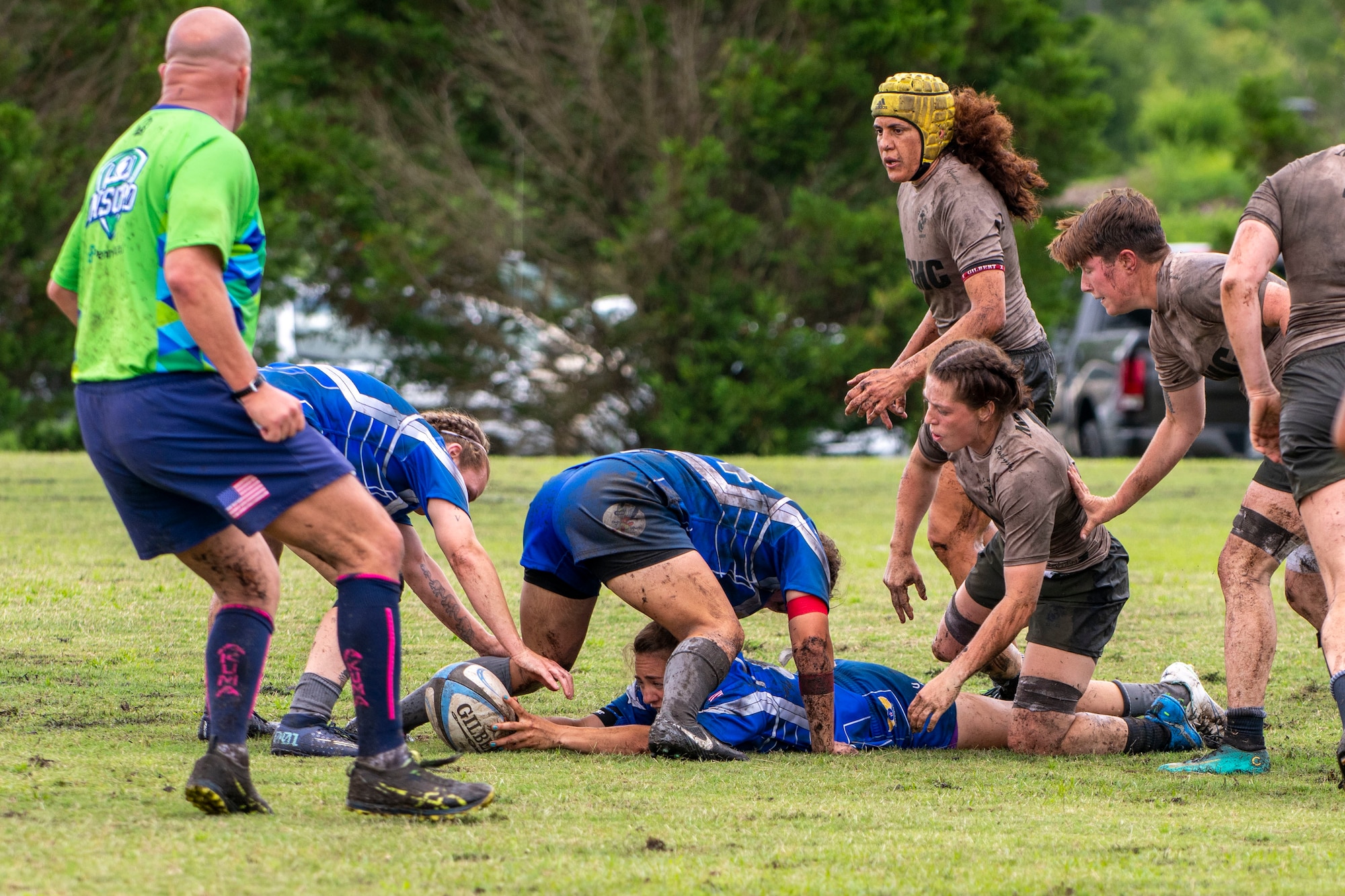 Members of the United States Air Force rugby team, blue, form a ruck during a game against the U.S. Marine Corps. Rugby team at the Annual Armed Forces Women’s Rugby Championship in Wilmington, North Carolina, June 26, 2021.