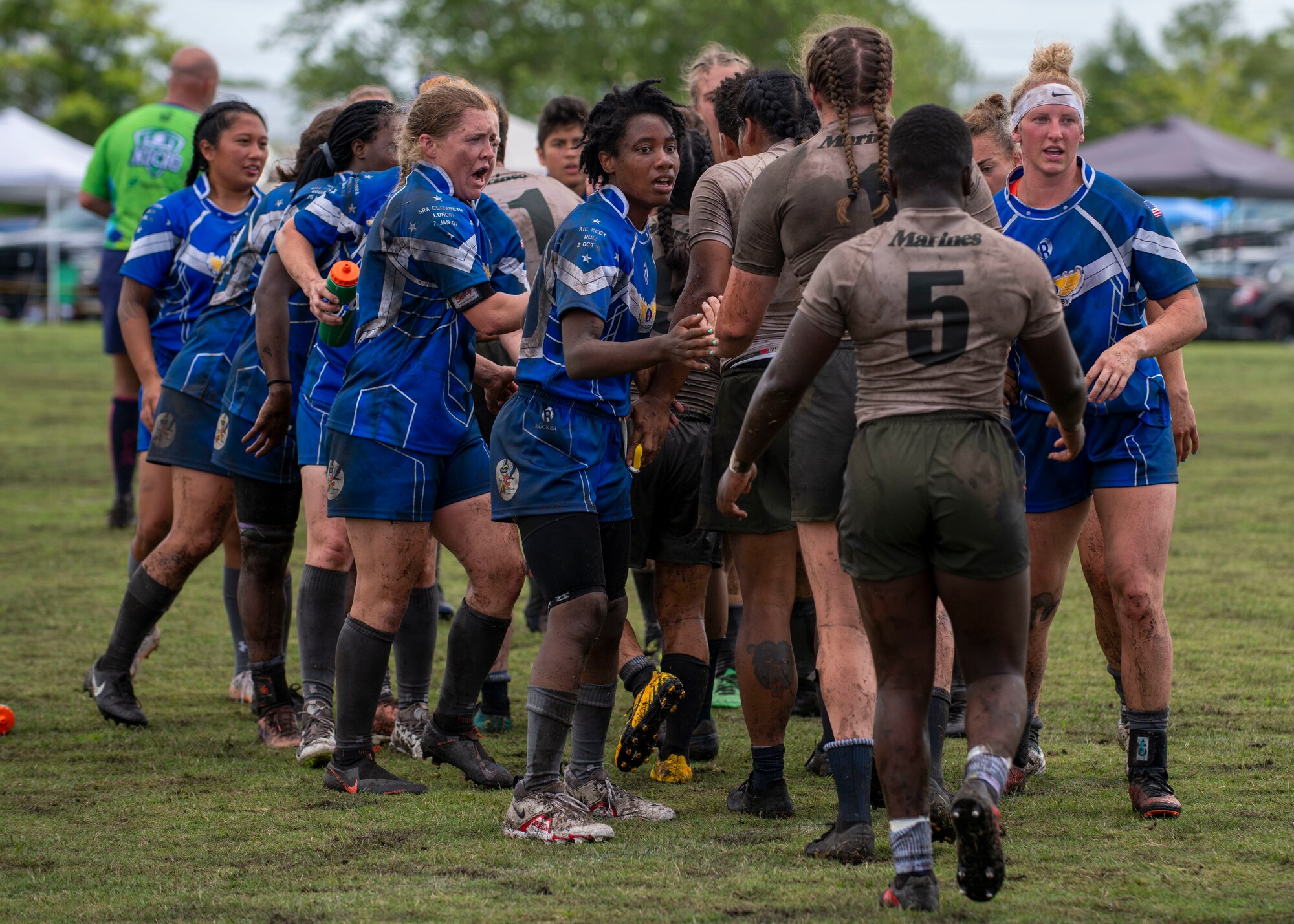 Members of the United States Air Force and Marine women’s rugby teams shake hands after a game at the Annual Armed Forces Women’s Rugby Championship in Wilmington, North Carolina, June 26, 2021.