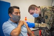 Spc. Christopher Valencia, combat medical specialist with Headquarters and Headquarters Company, 1st Battalion, 112 Infantry Regiment administers a COVID-19 vaccine to Romero Sergio at the Esperanza Community Vaccination Center in Philadelphia ON May 17, 2021. The Pennsylvania National Guard has been supporting COVID-19 vaccine sites across the Commonwealth since mid-March. PA Guard members have supported the administration of more than 500,000 COVID-19 vaccine doses. (Air National Guard photo by Staff Sgt. Ross Alexander Whitley / 111th Attack Wing)