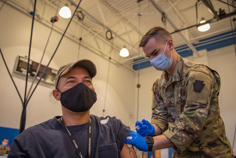 Cpl. Nathaniel Shaffer, a combat medical specialist with 2nd Battalion, 112th Infantry Regiment administers a COVID-19 vaccine to Daniel Cruz at the Esperanza Community Vaccination Center in Philadelphia on May 17, 2021. The Pennsylvania National Guard are supporting COVID-19 vaccine sites across the Commonwealth since mid-March. PA Guard members have supported the administration of more than 500,000 COVID-19 vaccine doses. (Air National Guard photo by Staff Sgt. Ross Alexander Whitley / 111th Attack Wing)
