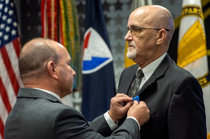 Barry W. Hoffman, U.S. Army Financial Management Command executive director, pins an Army Distinguished Civilian Service Medal on G. Eric Reid, a recently retired USAFMCOM Military Pay Operations director, during a special ceremony at the Maj. Gen. Emmett J. Bean Federal Center in Indianapolis May 26, 2021. The medal is the highest award given by the Secretary of the Army to Army civilian employees. (U.S. Army photo by Mark R. W. Orders-Woempner)