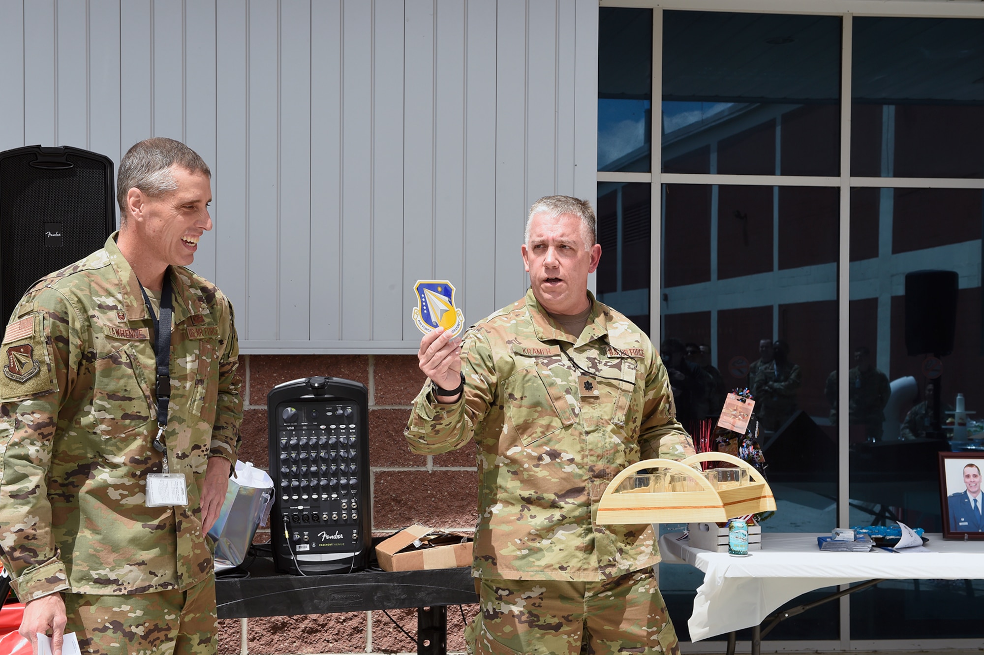 Lt. Col. Thomas Kramer, Deputy Commander, Det4, AFRL Information Directorate, makes a presentation to Col. Timothy J. Lawrence, during a farewell ceremony May 27 recognizing Lawrence for more than 33 years of military service. (Courtesy photo)