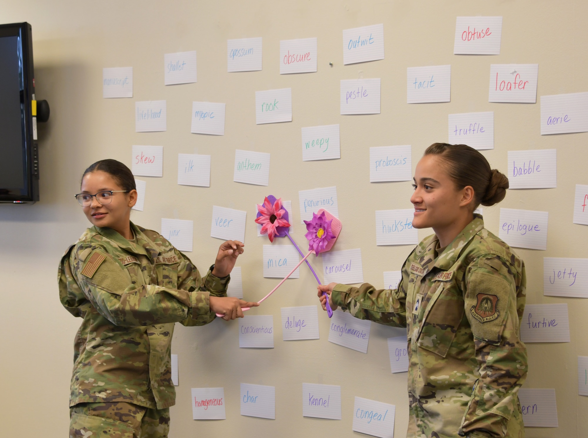 Cadet Patria Navedo and Cadet Alanis Delgado, Puerto Rico Project Language participants, play a grammar and vocabulary game during class at Maxwell Air Force Base, Alabama, June 25, 2021. The fly swat word game is a word comprehension game that gives the cadets practice and familiarity with words that would potentially be on the Air Force Officer’s Qualification Test. (U.S. Air Force photo by Senior Airman Rhonda Smith)