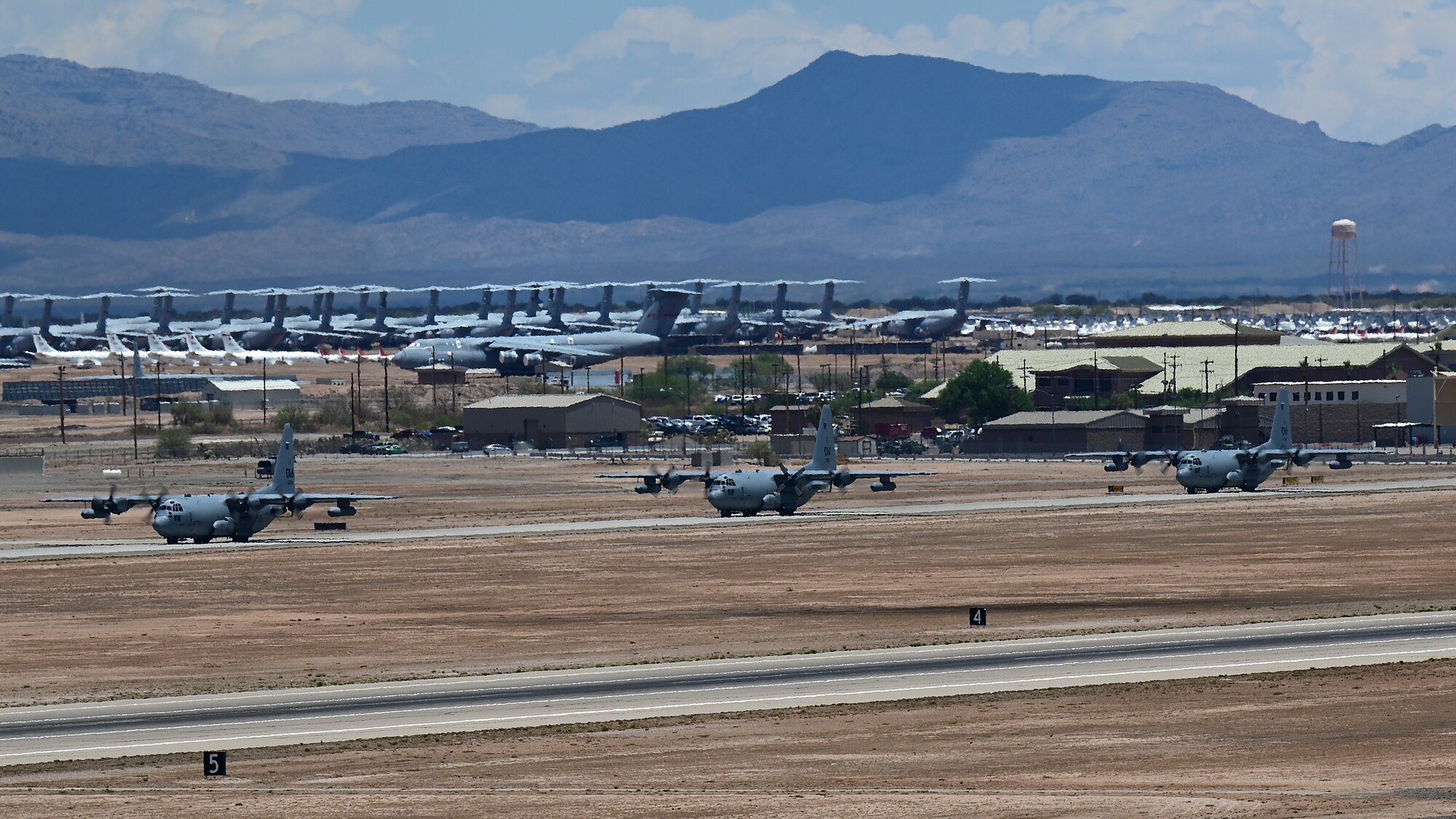 A photo of aircraft taxiing down a runway