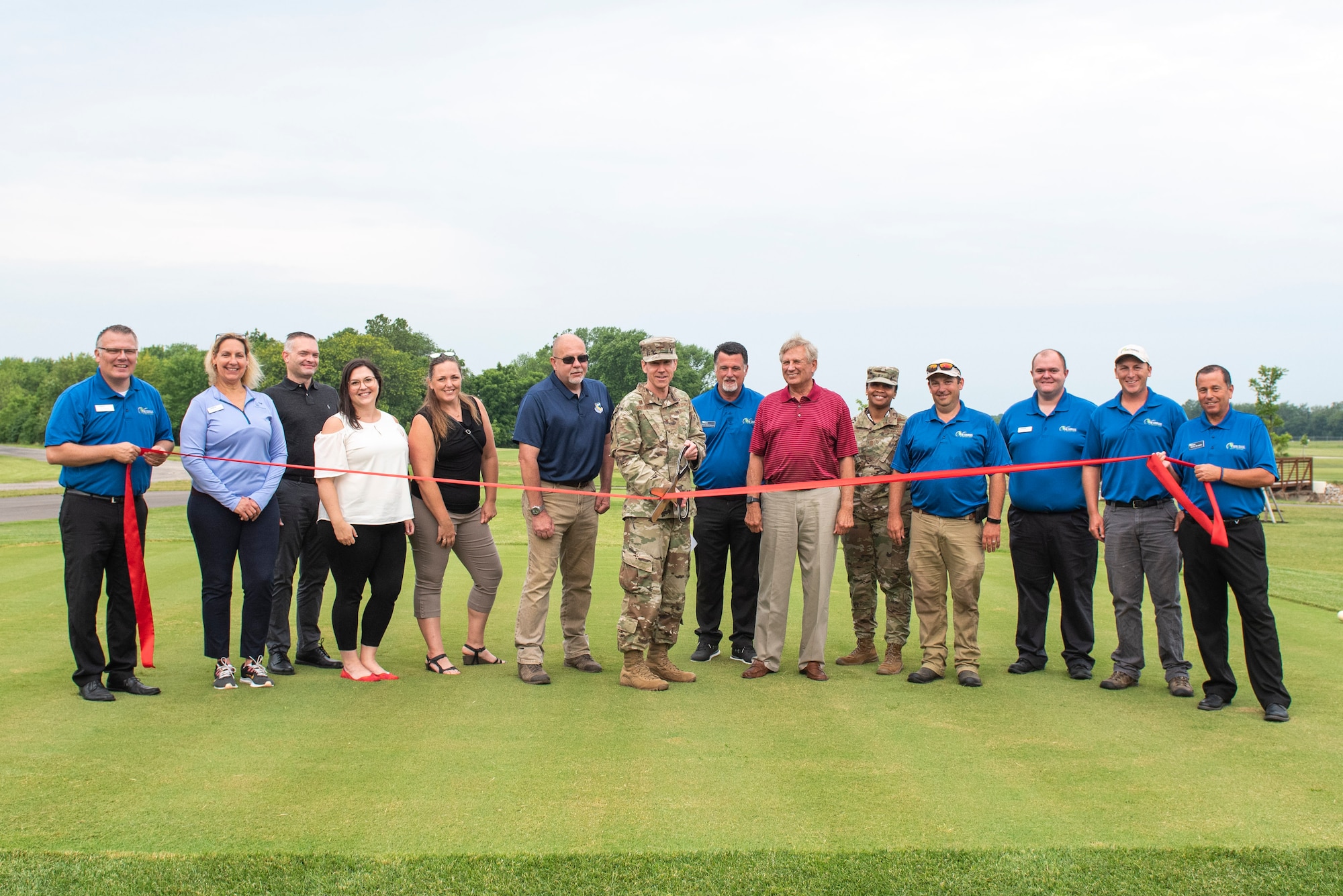 U.S. Air Force Col. Paul Burger, 88th Mission Support Group commander, along with other distinguished visitors, cut the ribbon of newly designed holes 7 and 8 of the Prairie Trace golf course, June 25, 2021, at Wright-Patterson Air Force Base, Ohio. The cutting marks the completion of the first phase of a multi-mission dollar program which required the previous holes to be moved to make room for the expansion of the National Air and Space Intelligence Center. (U.S. Air Force photo by Wesley Farnsworth)