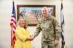 West Virginia National Guard Adjutant General Brig. Gen. William "Bill" Crane shakes hands with Lead Soldier and Family Readiness Specialist Amy long to congratulate her on the West Virginia National Guard's Family Assistance Program recognition being ranked first in the nation according to the National Guard Bureau’s mid-year scorecard. The Family Assistance Program connects service members and families with financial services, home and auto repair and even foster care for pets while a solider or airman is deployed, along with providing additional services to service members and veterans. (U.S. Army National Guard photo by Edwin L. Wriston)
