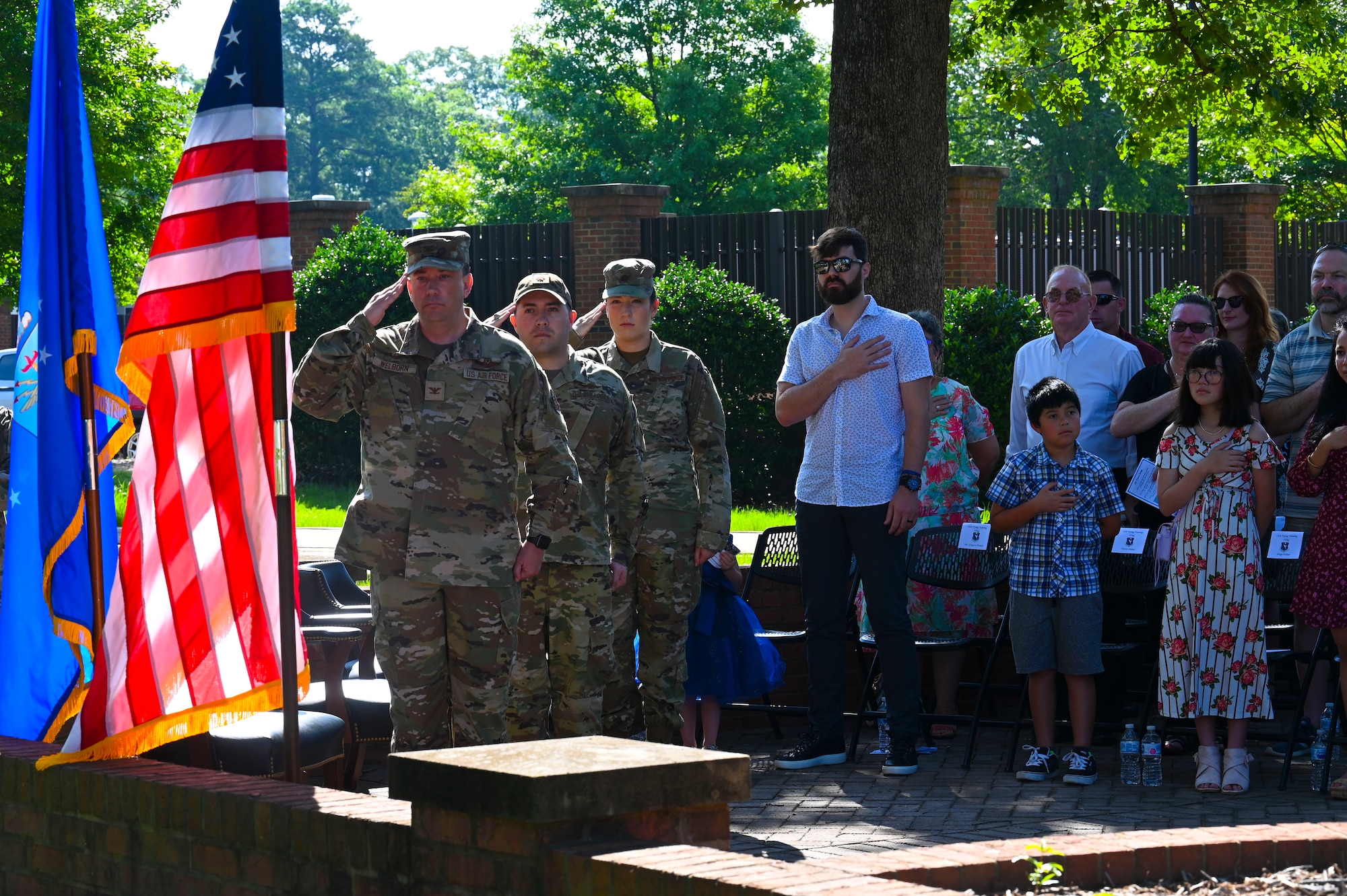 U.S. Air Force Col. Jeffrey Welborn, 14th Mission Support Group commander, Maj. Brandon Palmer, 14th Communications Squadron outgoing commander, and Maj. Elizabeth Rainwater, 14th CS incoming commander, salute the American Flag during the Nation Anthem at a Change of Command ceremony, July 1, 2021, on Columbus Air Force Base, Miss. The 14th Communications Squadron is responsible for providing the highest quality communications information tools to Columbus Air Force Base personnel. (U.S. Air Force photo by Airman 1st Class Jessica Haynie)