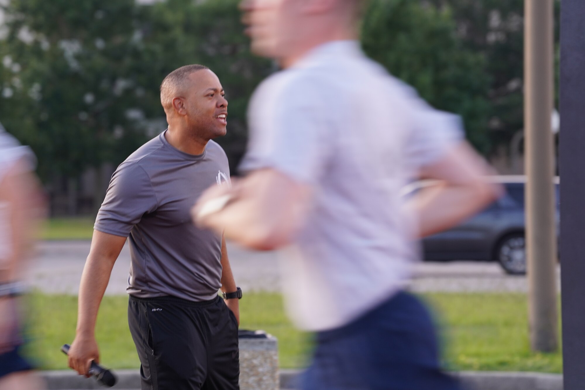 U.S. Air Force Tech. Sgt. Alvin Morris, 336th Training Squadron master military training leader, motivates Airmen in training during physical training at the Triangle track on Keesler Air Force Base, Mississippi, June 29, 2021. “An MTL consistently enforces standards of conduct and expectations to develop Airmen to be prepared to enter the operational Air Force,” said Morris. “We are the professional example for Airmen to emulate and first look at what a healthy leadership team looks like. It is our responsibility to inspire Airmen to take pride in serving and exhibit excellence in all we do.” (U.S. Air Force photo by Senior Airman Spencer Tobler)