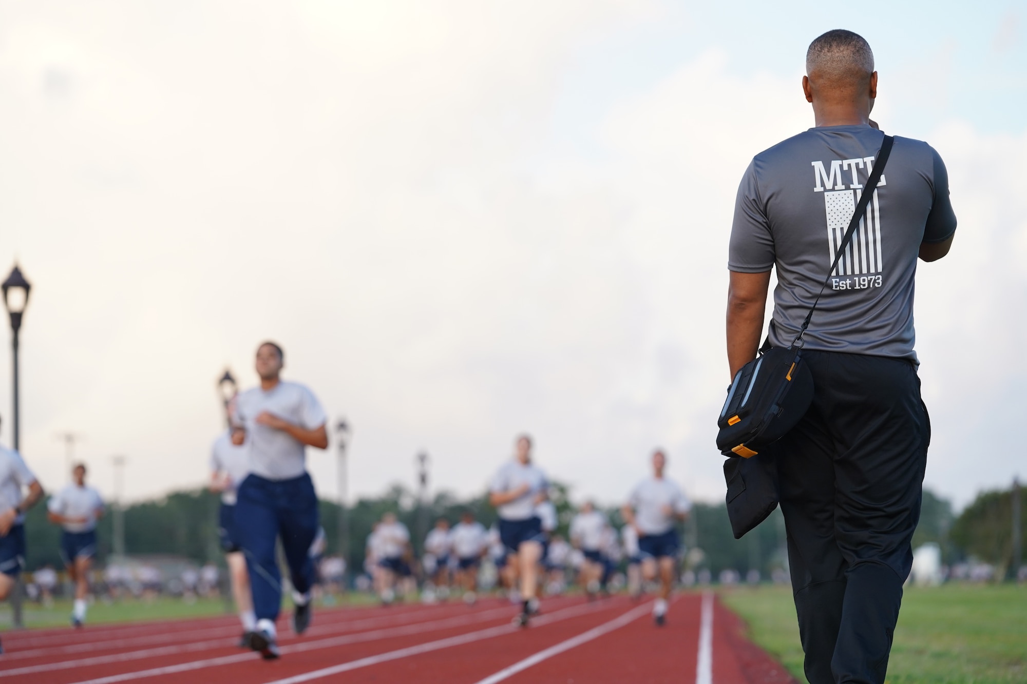 U.S. Air Force Tech. Sgt. Alvin Morris, 336th Training Squadron master military training leader, motivates Airmen in training at the Triangle track on Keesler Air Force Base, Mississippi, June 29, 2021. “An MTL consistently enforces standards of conduct and expectations to develop Airmen to be prepared to enter the operational Air Force,” said Morris. “We are the professional example for Airmen to emulate and first look at what a healthy leadership team looks like. It is our responsibility to inspire Airmen to take pride in serving and exhibit excellence in all we do.” (U.S. Air Force photo by Senior Airman Spencer Tobler)