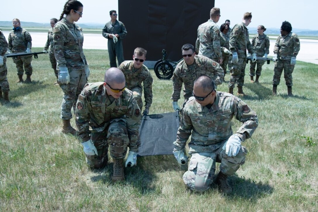 Members of the 28th Medical Group rehearse lifting a litter as a cohesive unit for exercise Golden Coyote on Ellsworth Air Force Base, S.D., June 16, 2021.