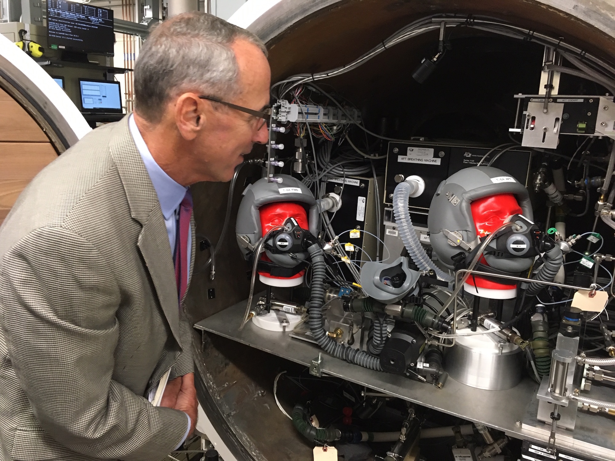 National Commission on Military Aviation Safety commissioner Gen. Raymond E. Johns, (USAF, Ret.) looks over testing equipment at the 711th Human Performance Wing’s On-board Oxygen Generation Systems (OBOGS) Laboratory Sept. 11, 2019 during the commission’s visit to Wright-Patterson Air Force Base. (National Commission on Military Aviation Safety photo/Bryan Whitman)