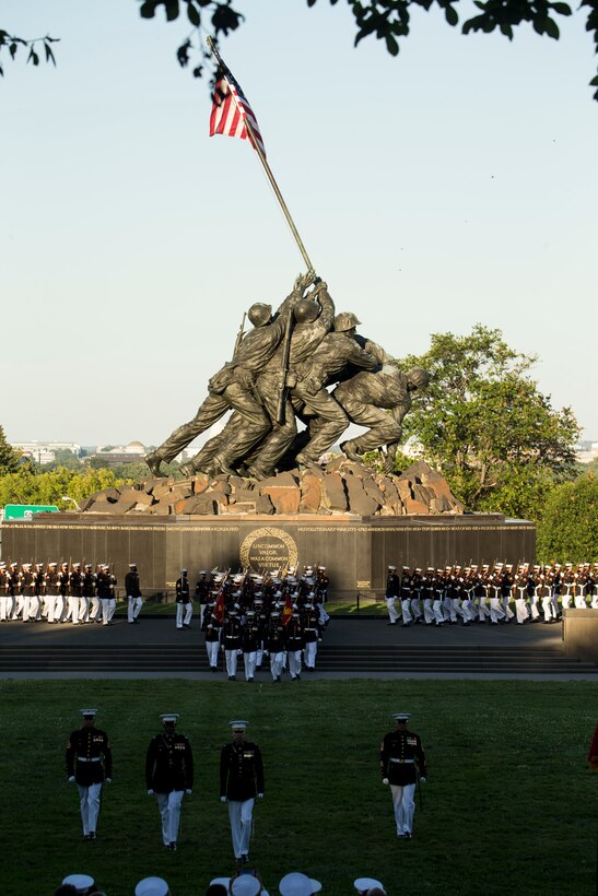 Marines with Marine Barracks Washington march into formation during a Tuesday Sunset Parade at the Marine Corps War Memorial, Arlington, Va., June 29, 2021.