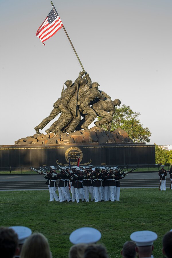 The U.S. Marine Corps Silent Drill Platoon conducts their “Bursting Bomb” sequence during a Tuesday Sunset Parade at the Marine Corps War Memorial, Arlington, Va., June 29, 2021. The hosting official for the evening was Brig. Gen. Michael J. Borgschulte, Director, Manpower Management Division, and The Honorable James F. Geurts Under Secretary of the Navy, was the guest of honor. (U.S. Marine Corps photo by Lance Cpl. Allen Sanders)