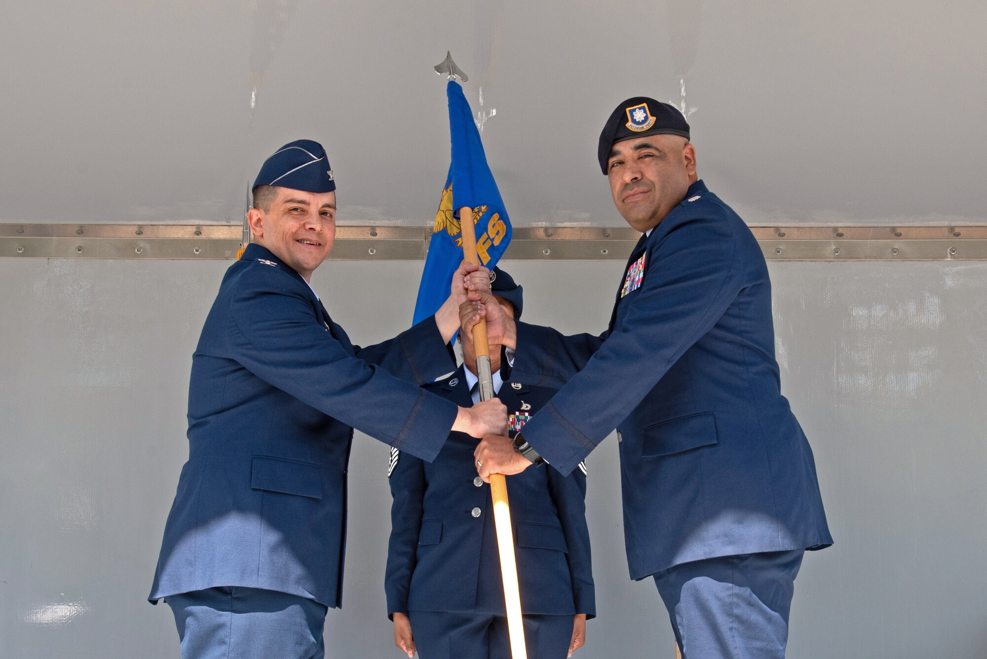 U.S. Air Force Col. David J. Wilson, 21st Mission Support Group commander, left, passes the 21st Security Forces Squadron guidon during the assumption of command ceremony to U.S. Air Force Lt. Col. Jaime Hernandez Jr., incoming 21st SFS commander, at Peterson Air Force Base, Colorado, June 30, 2021. The 21st SFS mission is to protect, defend and fight to enable Air Force, Joint and Coalition missions. (U.S. Space Force photo by Airman Aaron Edwards)