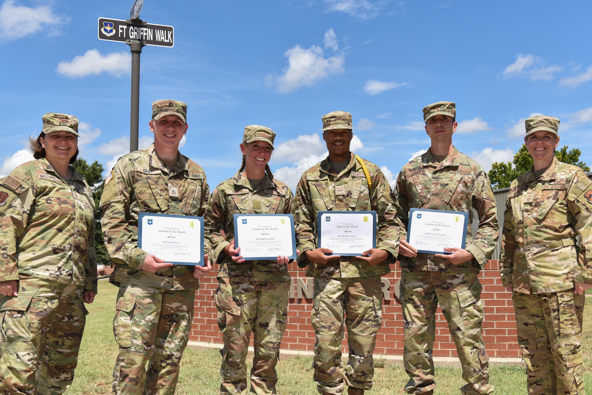 U.S. Air Force Col. Angelina Maguinness, 17th Training Group commander, students from across the 17th TRG, and Chief Master Sgt. Breana Oliver, 17th TRG superintendent, pose for a picture on Goodfellow Air Force Base, Texas, June 29, 2021. Each student was nominated to receive their award based on votes by fellow students and instructors of their squadrons. (U.S. Air Force photo by Senior Airman Jermaine Ayers)