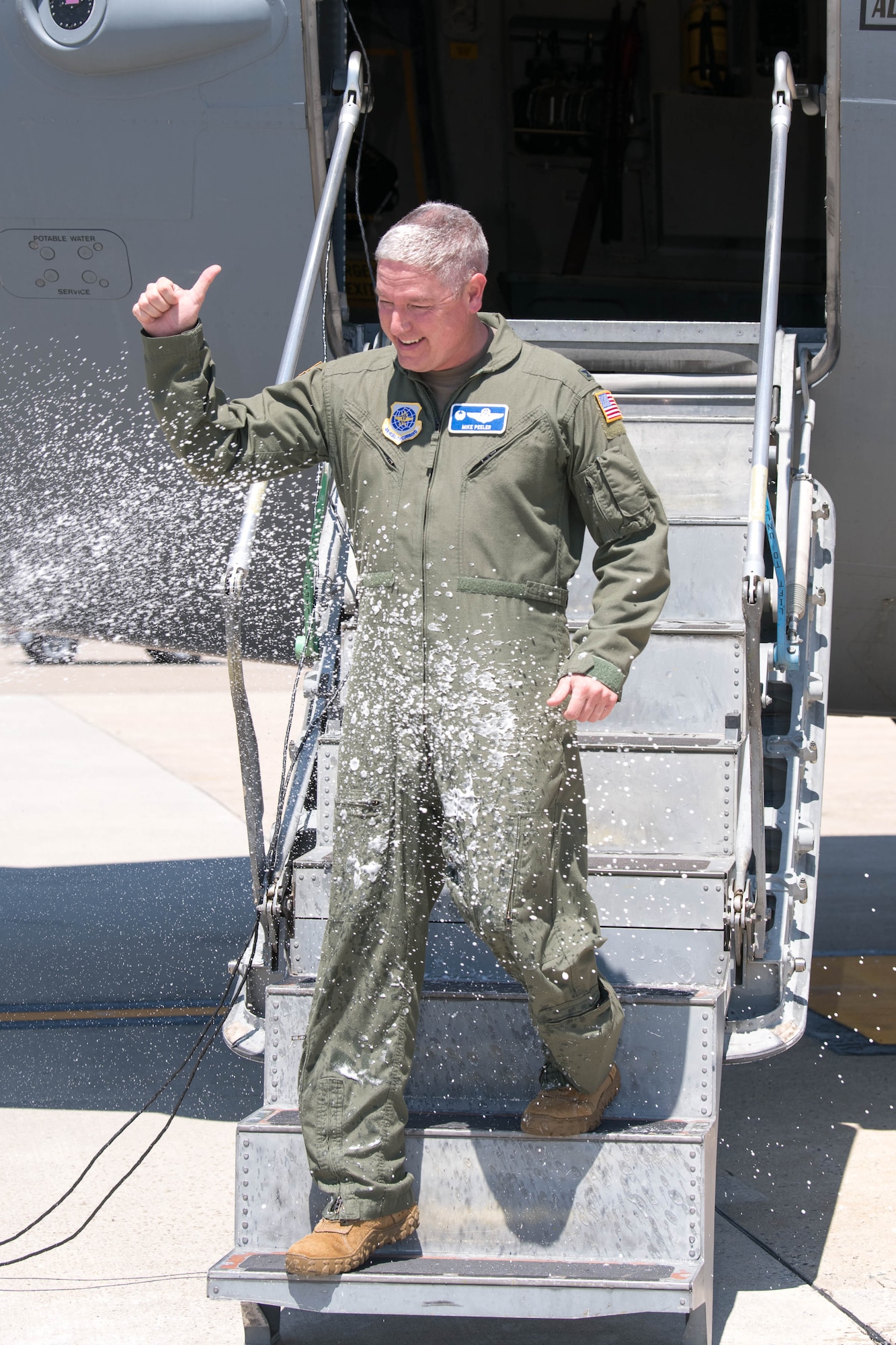 Col. Mike Peeler, 436th Operations Group commander, greets a crowd of friends and coworkers following his final flight as group commander at Dover Air Force Base, Delaware, June 30, 2021. Peeler served as commander for two years. (U.S. Air Force photo by Mauricio Campino)