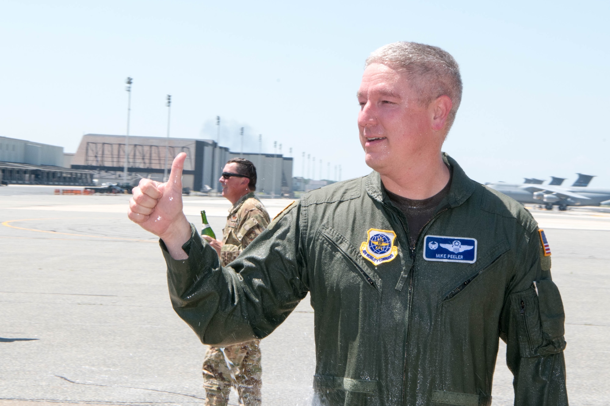 Col. Mike Peeler, 436th Operations Group commander, greets a crowd of friends and coworkers following his final flight as group commander at Dover Air Force Base, Delaware, June 30, 2021. Peeler served as commander for two years. (U.S. Air Force photo by Mauricio Campino)