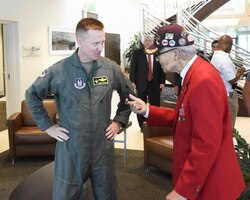 Brig. Gen. Mike Schultz, the 442d Fighter Wing commander, speaks with Tuskegee Airman retired Brig. Gen. Charles E. McGee