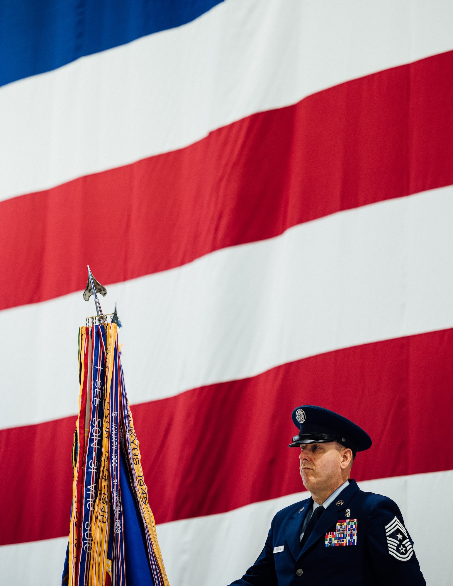 Chief Master Sgt. Chuck Frizzell, 375th Air Mobility Wing command chief, stands posted with the 375th AMW’s guidon prior to the change of command ceremony transferring leadership to Col. Chris Robinson on Scott Air Force Base, Illinois, July 1, 2021. The change of command ceremony represents a time-honored military tradition providing an opportunity for Airmen to witness the transfer of power to their newly appointed commanding officer. (U.S. Air Force photo by Tech. Sgt. Jordan Castelan)