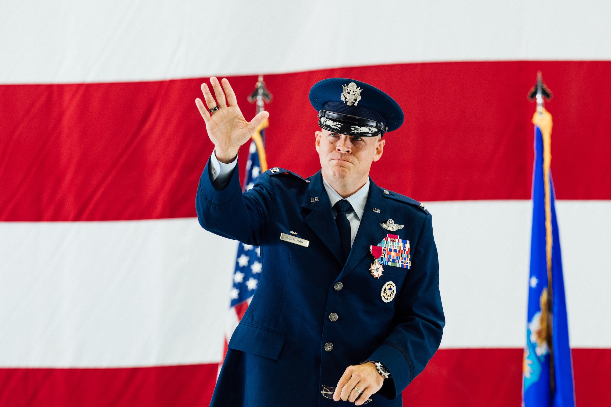 Col. Scot Heathman, outgoing 375th Air Mobility Wing commander, waves goodbye to the men and women of Team Scott after relinquishing command and completing his two-year tour as the leader of the 375th AMW on Scott Air Force Base, Illinois, July 1, 2021. Heathman will assume the role as vice commander of the 18th Air Force after departing the 375th AMW. (U.S. Air Force photo by Tech. Sgt. Jordan Castelan)
