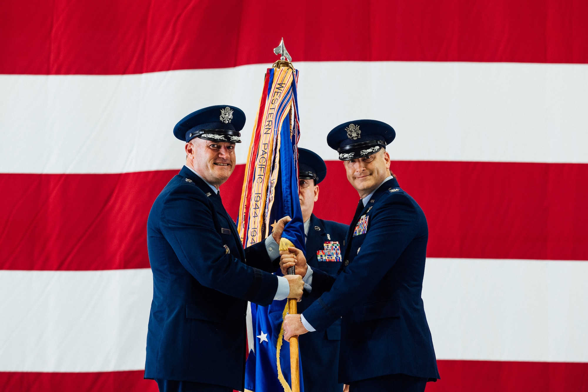 Col. Chris Robinson, right, 375th Air Mobility Wing commander, assumes command of the 375th AMW after receiving the Wing’s guidon from Maj. Gen. Thad Bibb, Jr., 18th Air Force commander, on Scott Air Force Base, Illinois, July 1, 2021. The change of command ceremony represents a time-honored military tradition providing an opportunity for Airmen to witness the transfer of power to their newly appointed commanding officer. (U.S. Air Force photo by Tech. Sgt. Jordan Castelan)