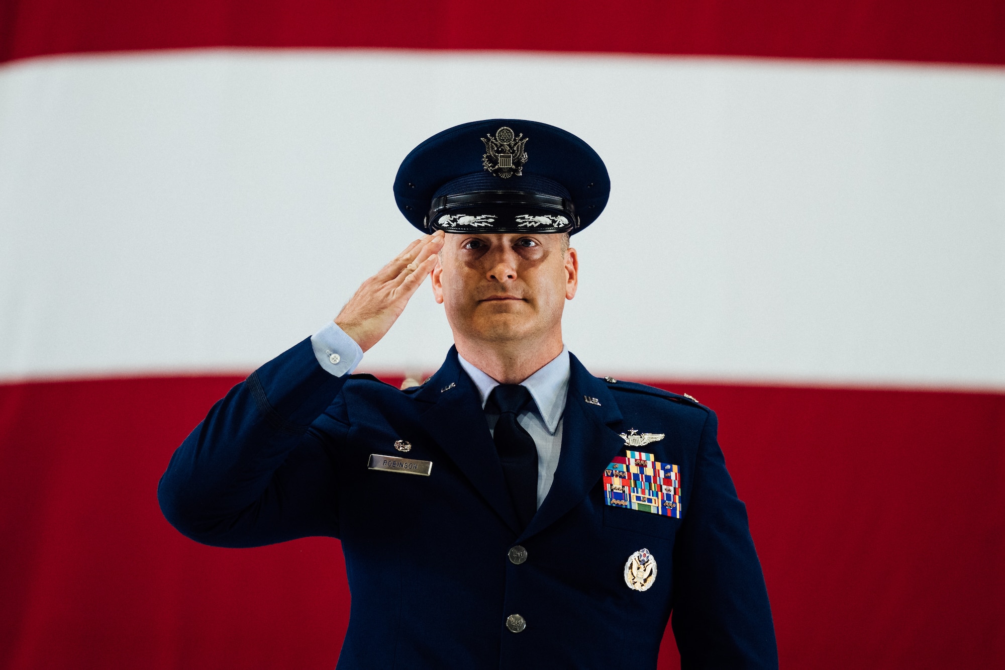 Col. Chris Robinson, 375th Air Mobility Wing commander, renders his first salute to members of Team Scott and the Showcase Wing after assuming command of the 375th AMW on Scott Air Force Base, Illinois, July 1, 2021. The change of command ceremony represents a time-honored military tradition providing an opportunity for Airmen to witness the transfer of power to their newly appointed commanding officer. (U.S. Air Force photo by Tech. Sgt. Jordan Castelan)