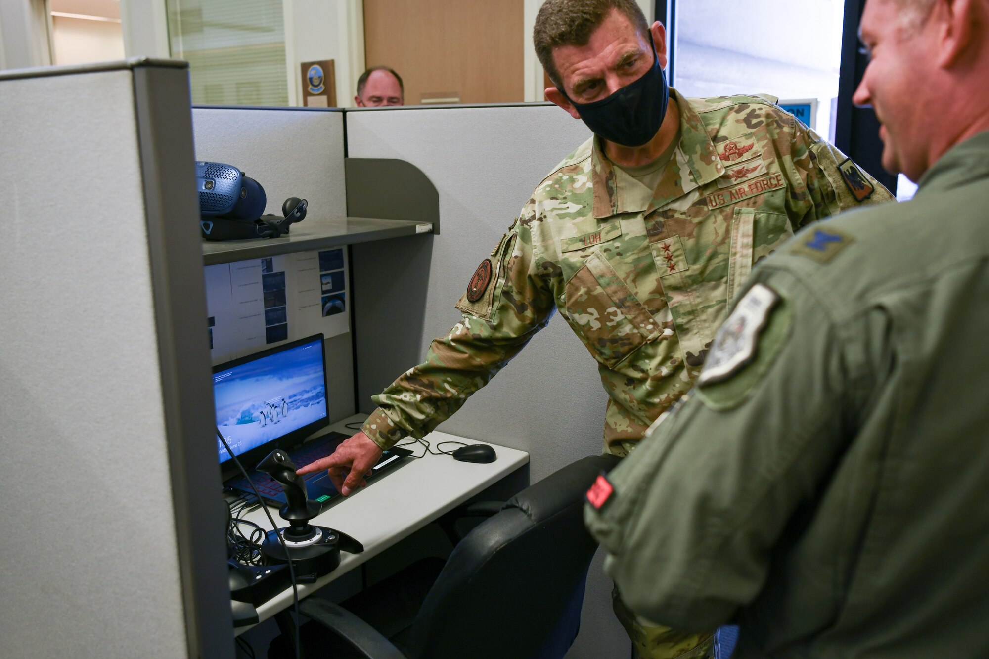 Lt. Gen Loh observes simulator setup