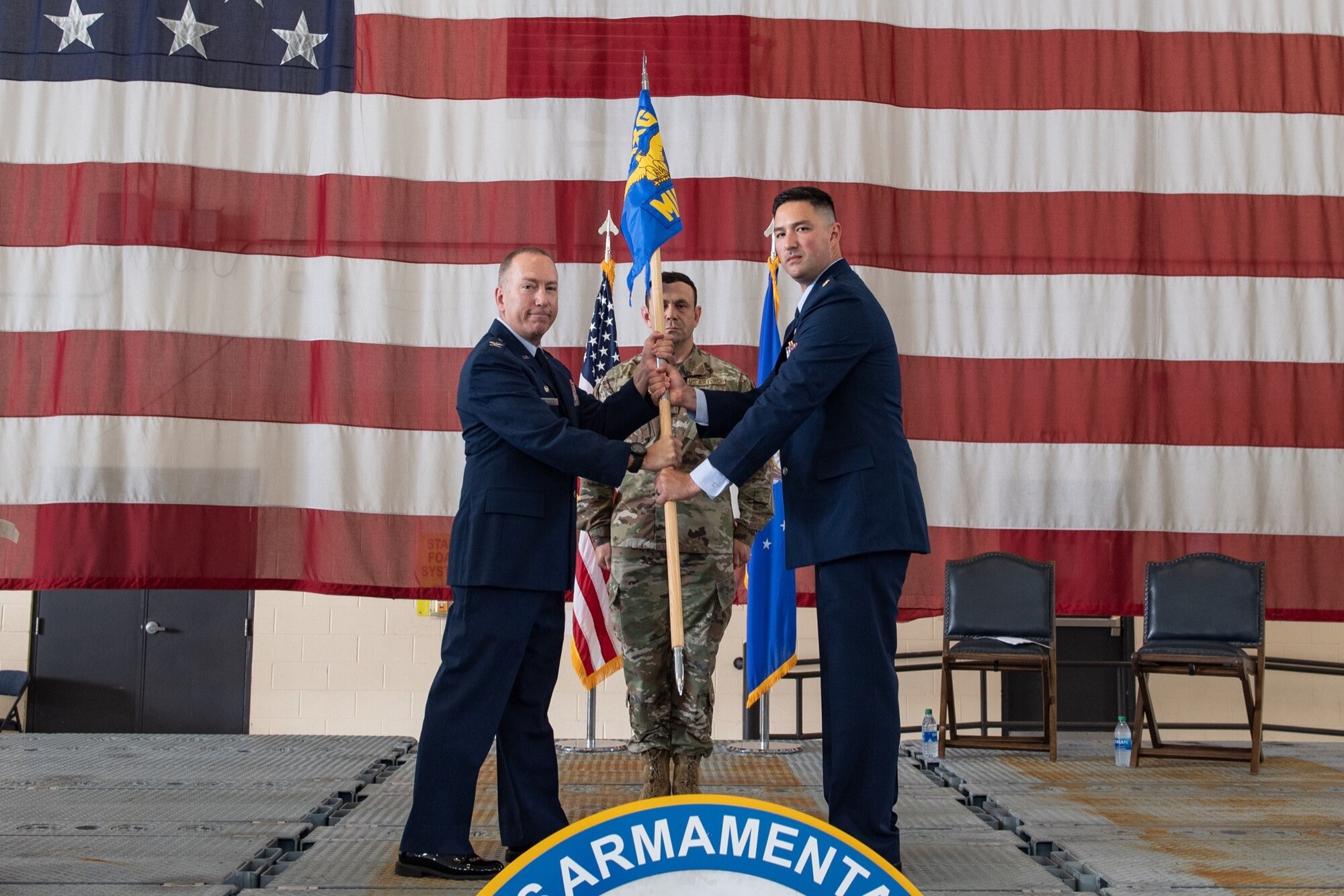 U.S. Air Force Maj. William Hichney, 23d Munitions Squadron commander, takes the command guidon from Col. Stephen Harvey, 23d Maintenance Group commander, July 1, 2021, at Moody Air Force Base, Georgia. The 23d MUNS is being reactivated after 44 years of dormancy. (U.S. Air Force photo by Senior Airman John Crampton)