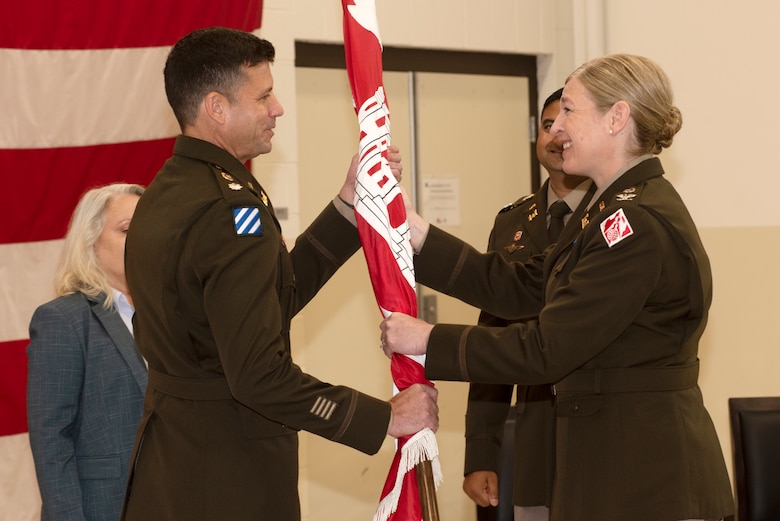 Col. Kimberly A. Peeples (Right), U.S. Army Corps of Engineers Great Lakes and Ohio River Division commander, passes the Nashville District flag to Lt. Col. Joe M. Sahl as he took command of the Nashville District during a change of command ceremony July 1, 2020 at the Tennessee National Guard Armory in Nashville, Tenn. (USACE photo by Lee Roberts)