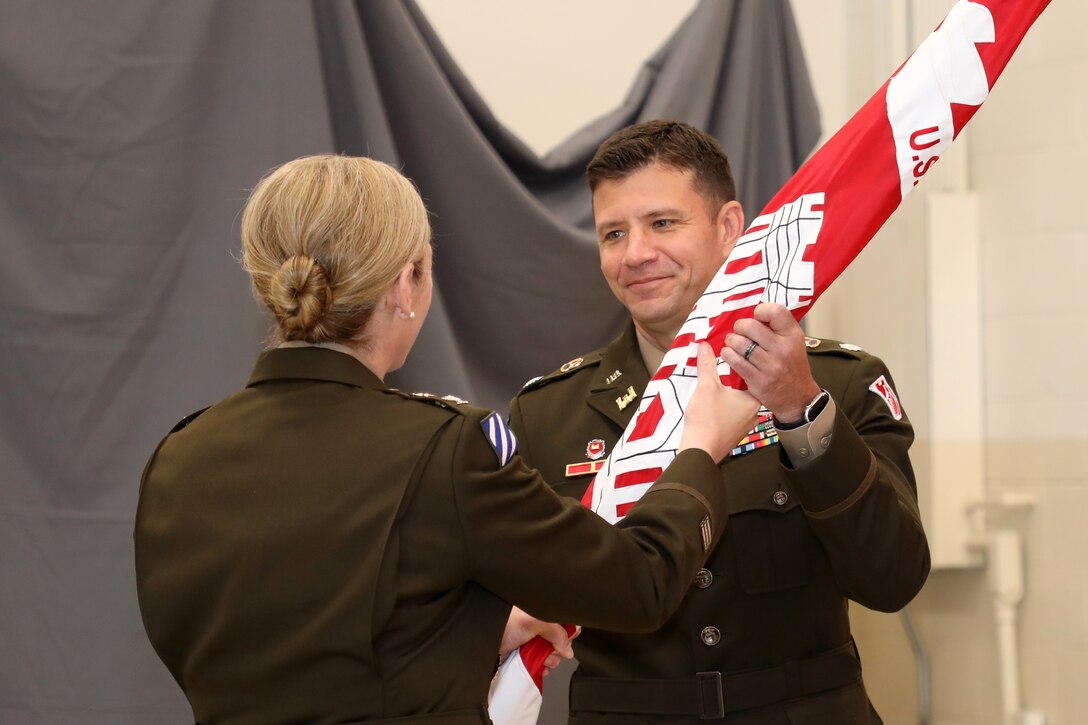 Col. Kimberly A. Peeples (Left), U.S. Army Corps of Engineers Great Lakes and Ohio River Division commander, passes the Nashville District flag to Lt. Col. Joe M. Sahl as he took command of the Nashville District during a change of command ceremony July 1, 2020 at the Tennessee National Guard Armory in Nashville, Tenn. (USACE photo by Michael May)